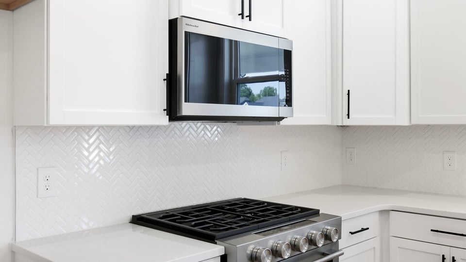 Kitchen and island with quartz countertops.