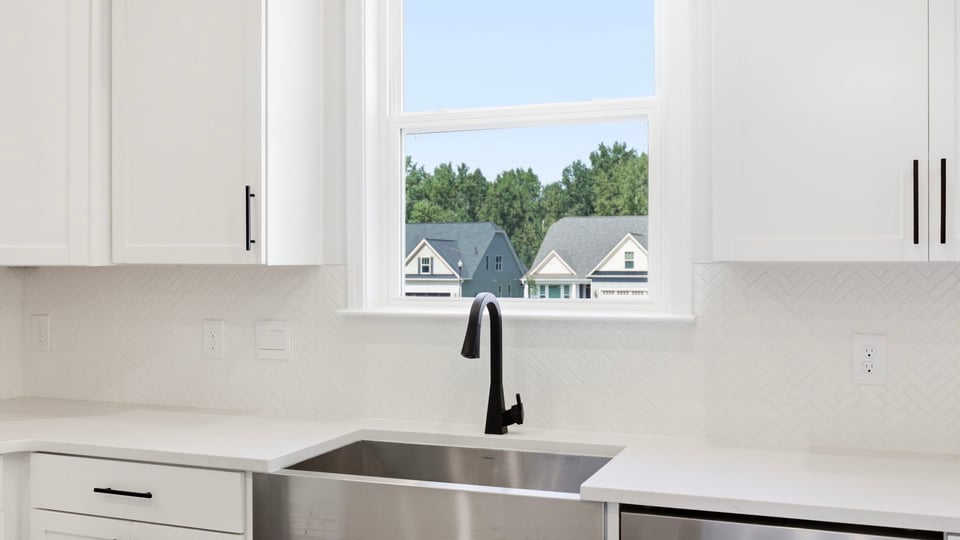 Kitchen and island with quartz countertops.