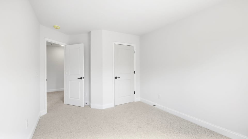 Bedroom with carpet and window.