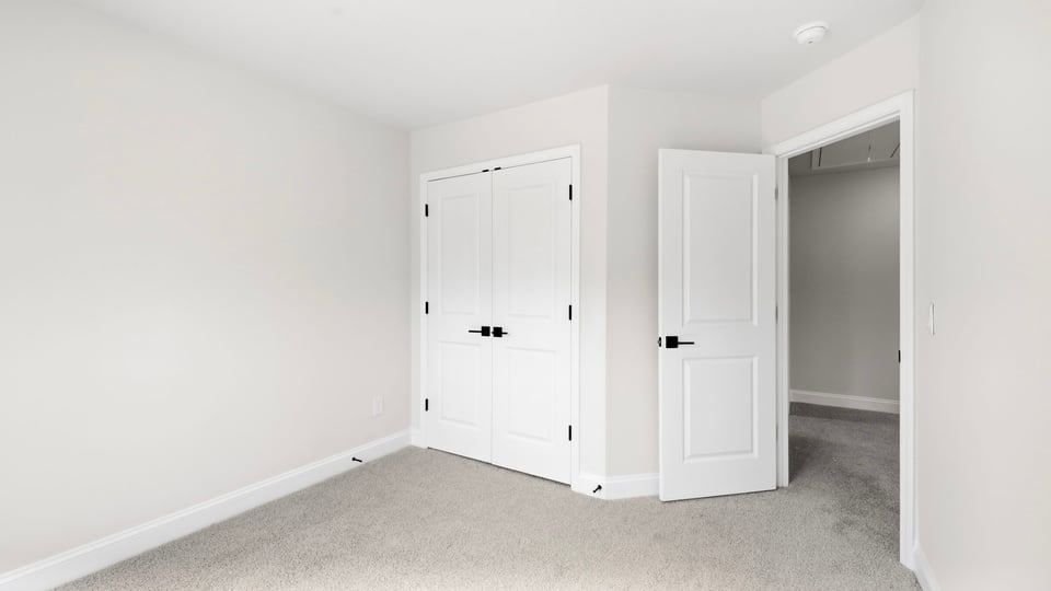 Bedroom with carpet and window.