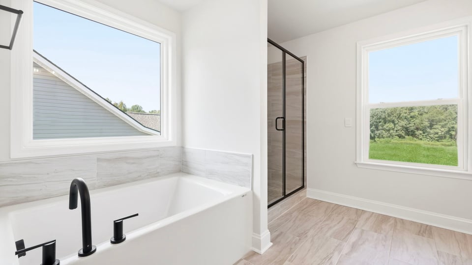 Bathroom with bathtub and window.
