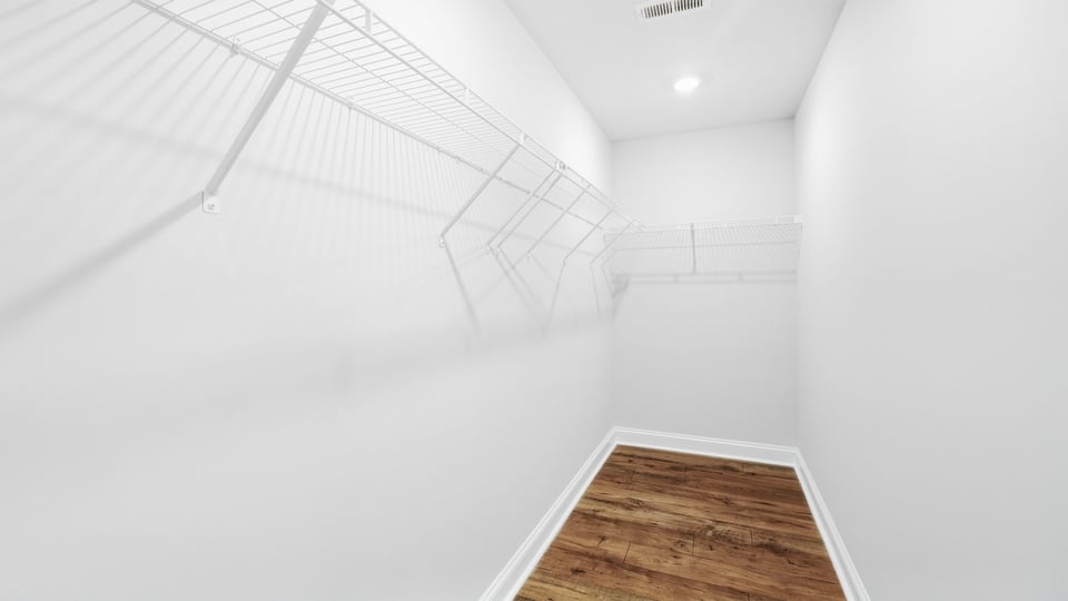 Closet with hanging storage racks.