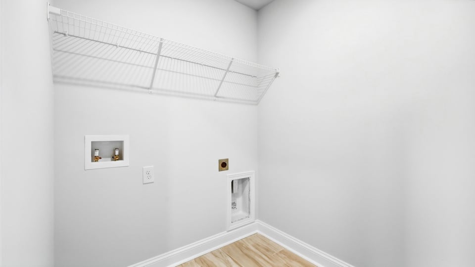 Laundry room with hanging storage racks.