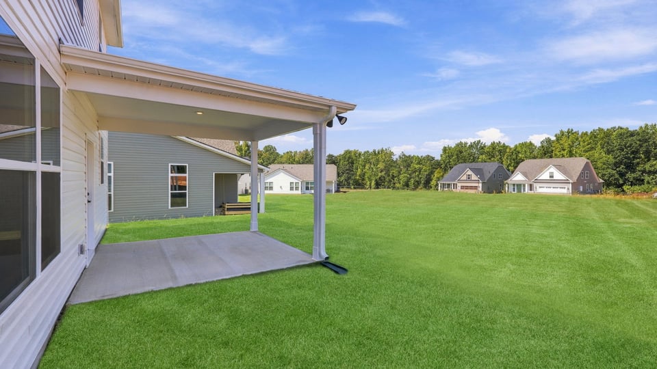 Back exterior of home with covered patio.