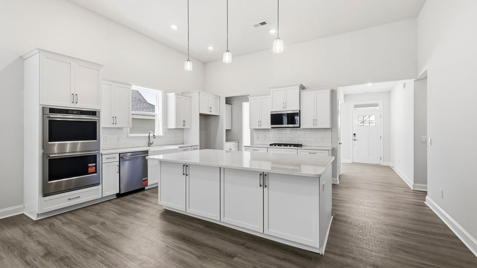 Kitchen and island with quartz countertops.