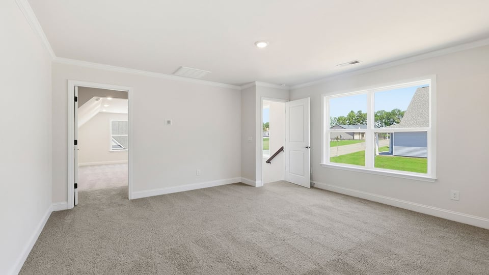 Bedroom with carpet and window.
