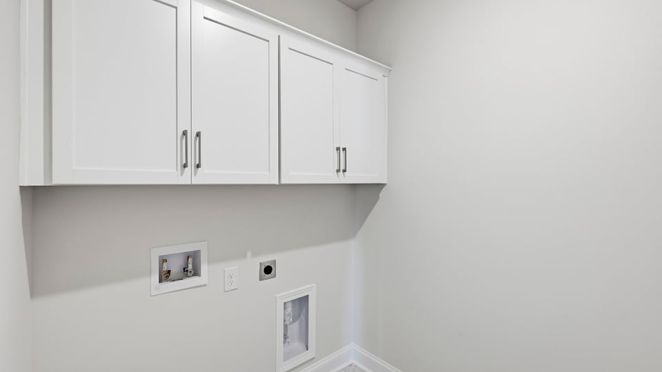 Laundry room with cabinets.