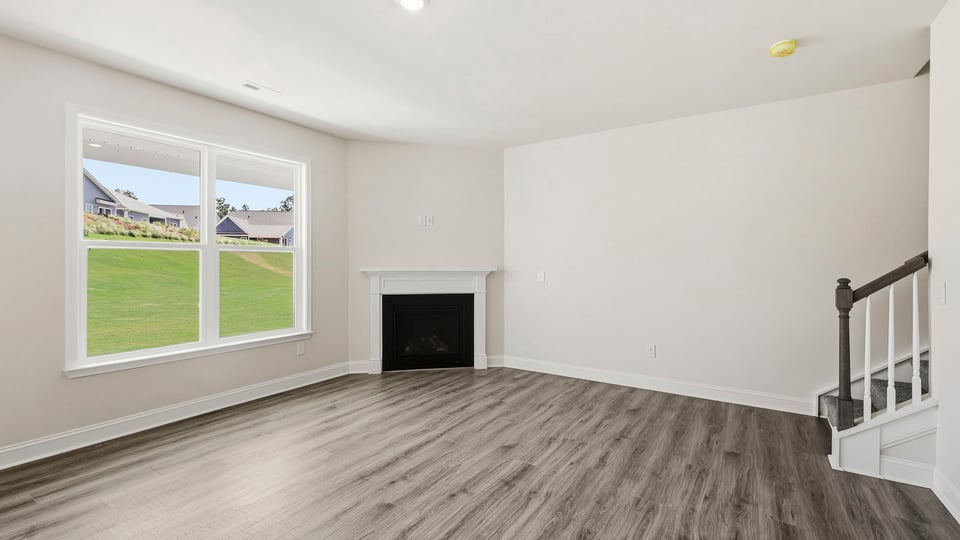 Living room with fireplace and windows.