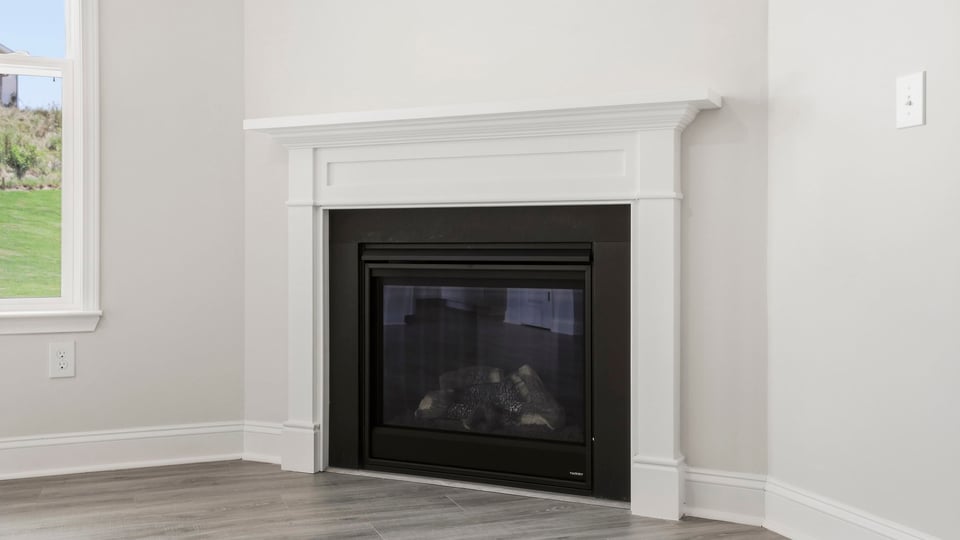 Living room with fireplace and windows.
