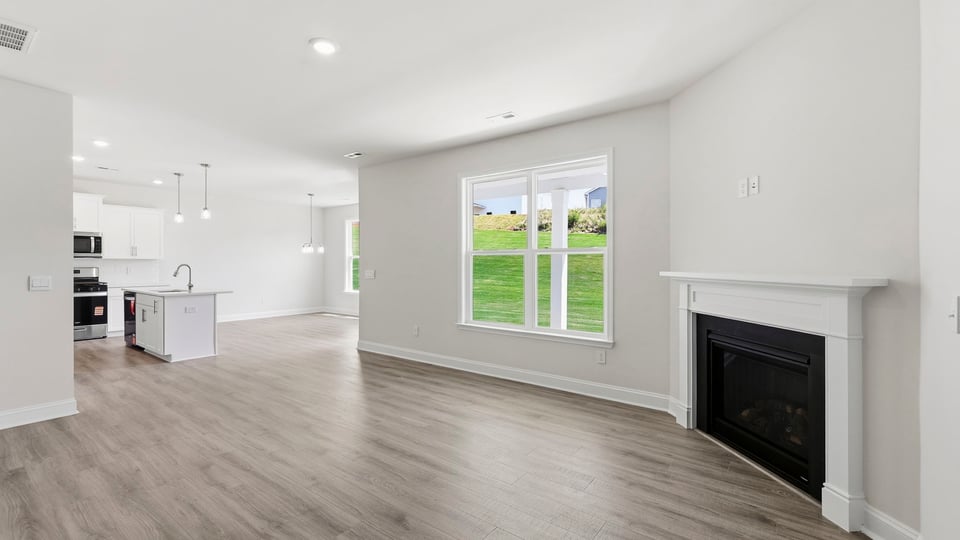 Living room with fireplace and windows.