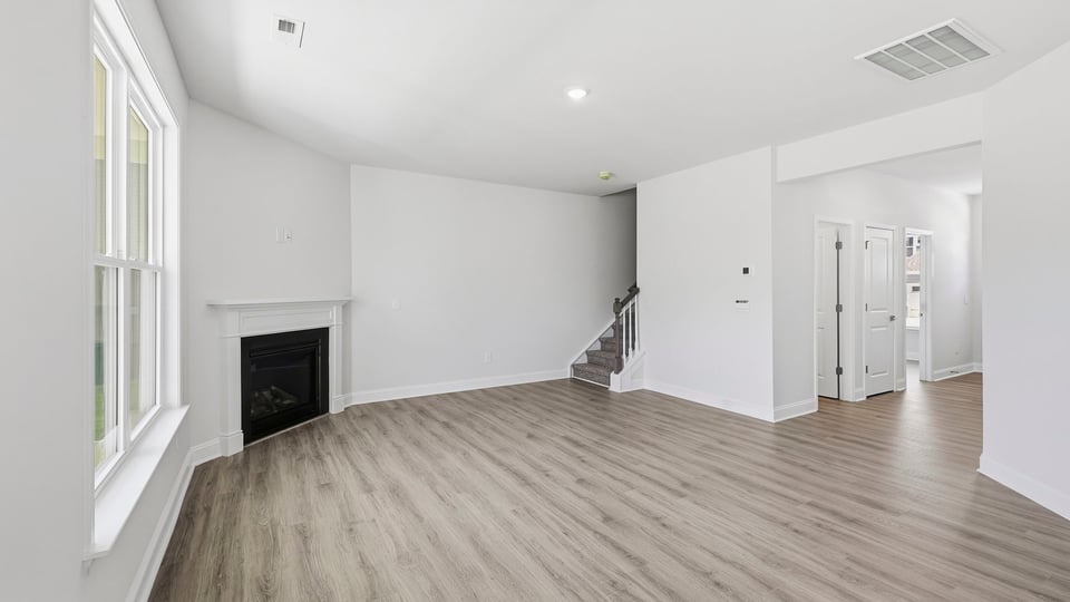 Living room with fireplace and windows.