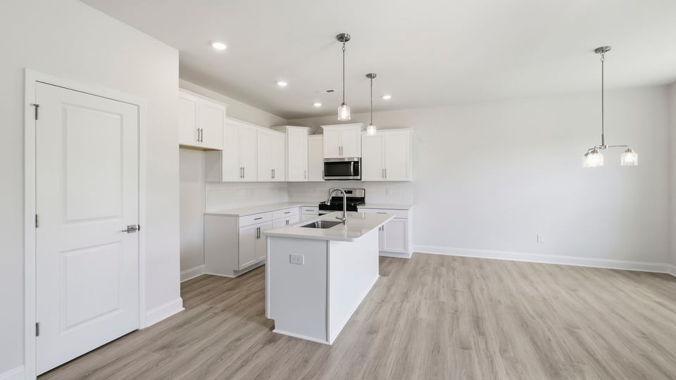 Kitchen and island with quartz countertops.