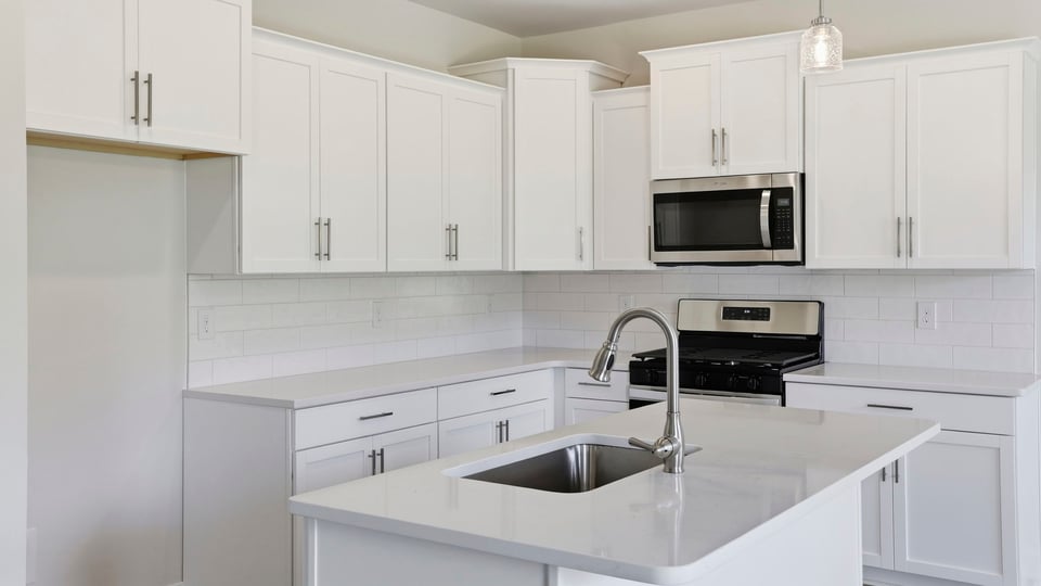 Kitchen and island with quartz countertops.