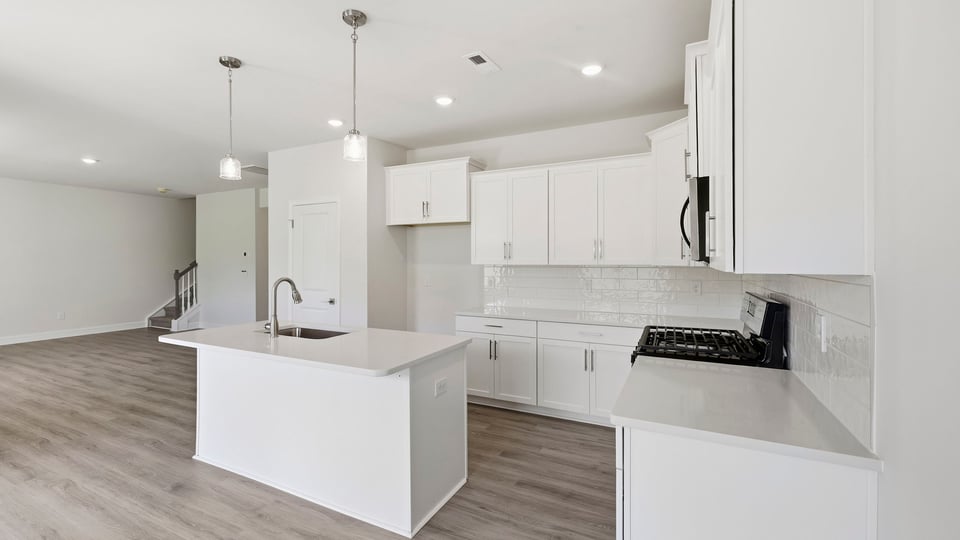Kitchen and island with quartz countertops.