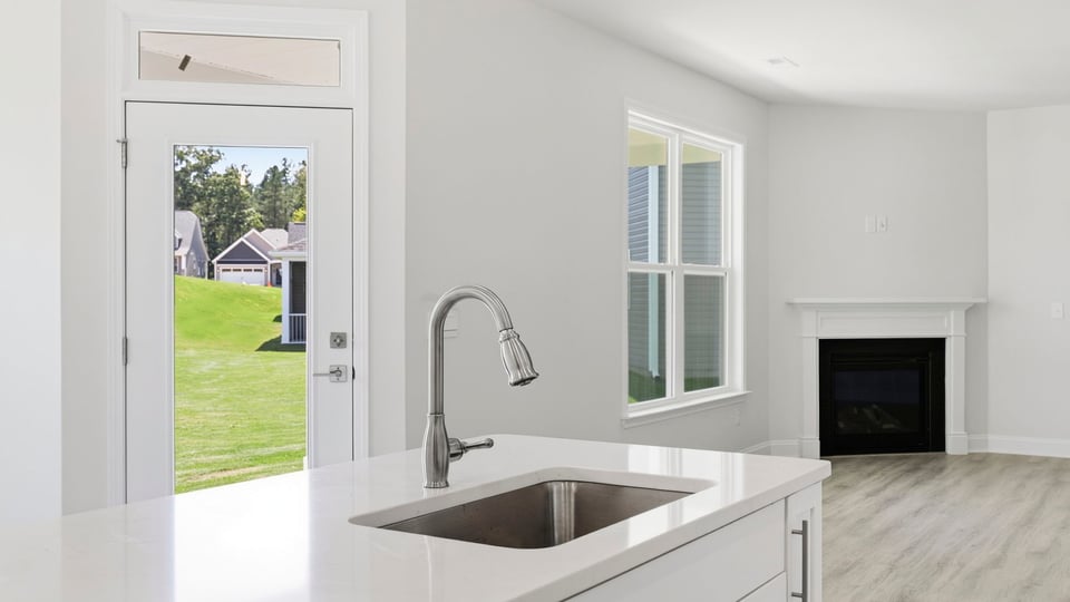 Kitchen and island with quartz countertops.