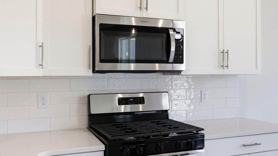 Kitchen and island with quartz countertops.