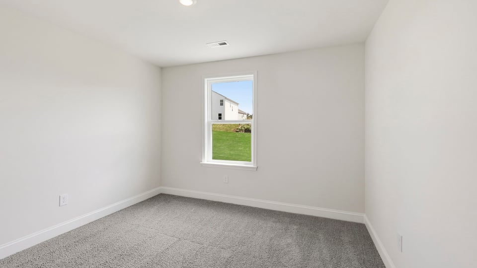 Bedroom with carpet and window.