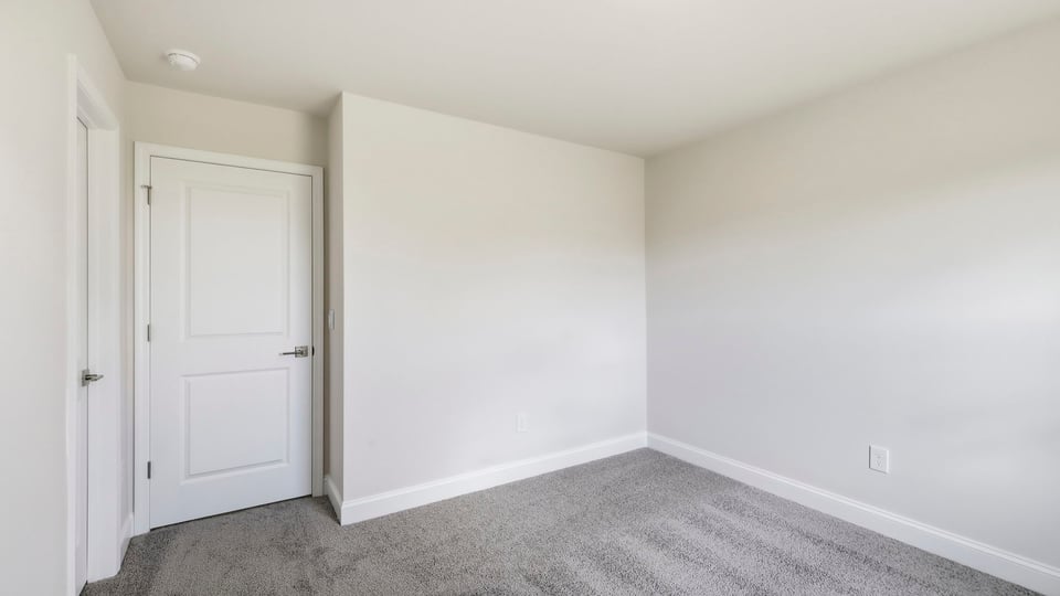 Bedroom with carpet and window.