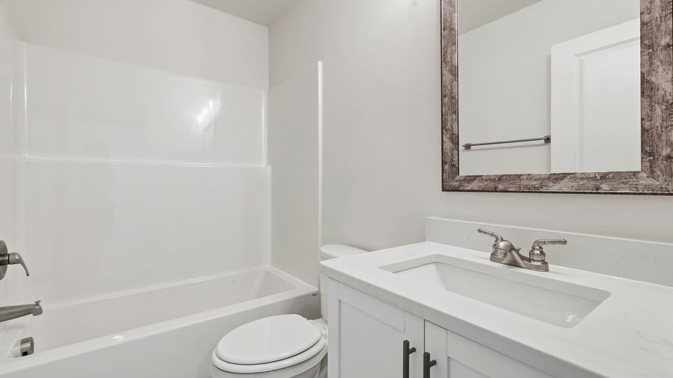 Bathroom with single vanity sink and bathtub.