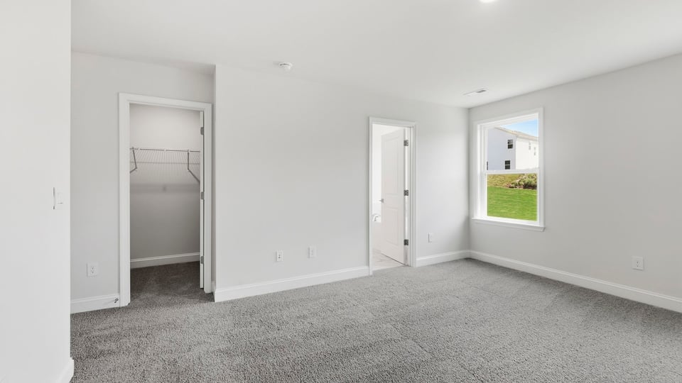 Bedroom with carpet and windows.