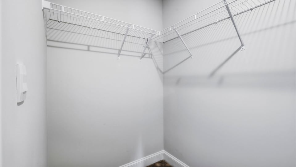 Closet with hanging storage racks.