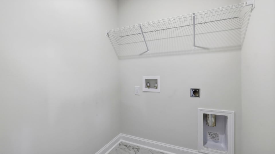 Laundry room with hanging storage racks.