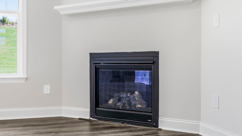 Living room with window and fireplace.