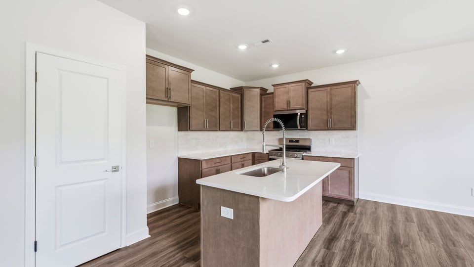 Kitchen and island with quartz countertops.