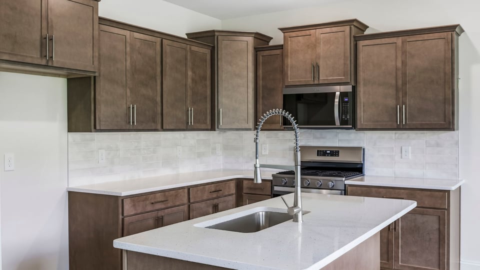 Kitchen and island with quartz countertops.