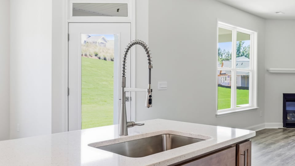 Kitchen and island with quartz countertops.