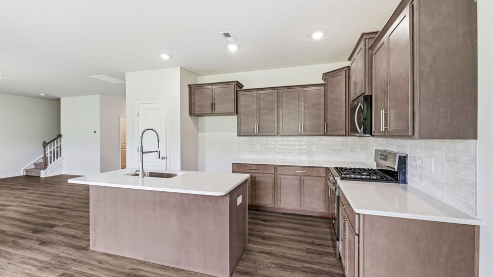 Kitchen and island with quartz countertops.