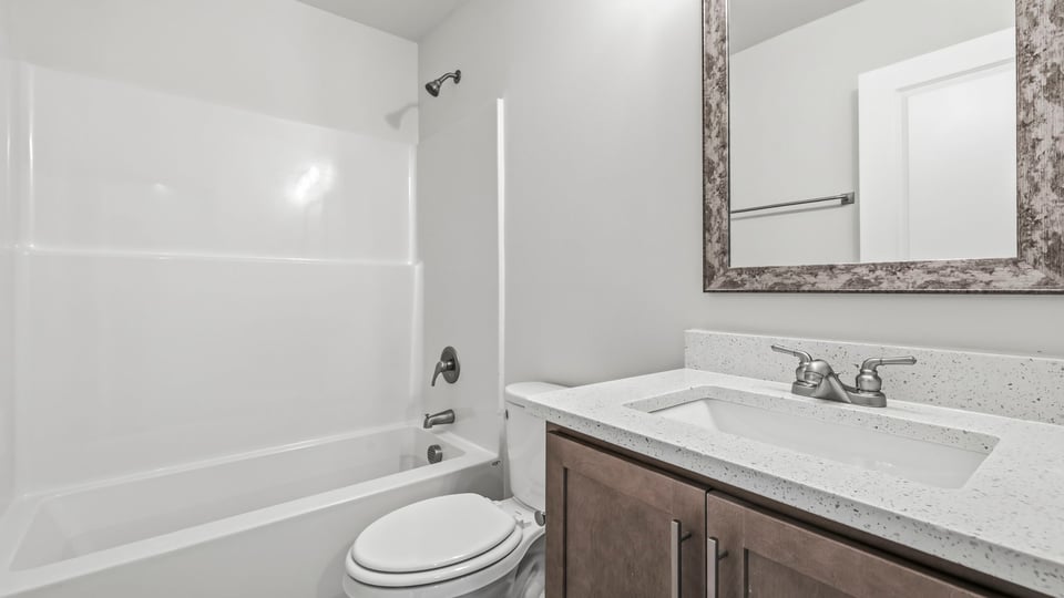 Bathroom with bathtub and single vanity sink.