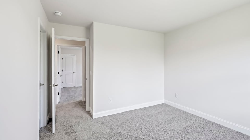 Bedroom with carpet and window.