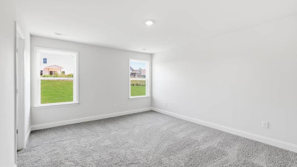 Bedroom with carpet and window.