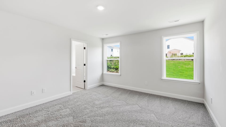 Bedroom with carpet and window.