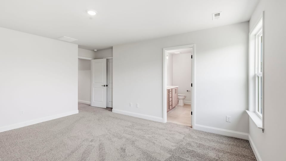 Bedroom with carpet and window.