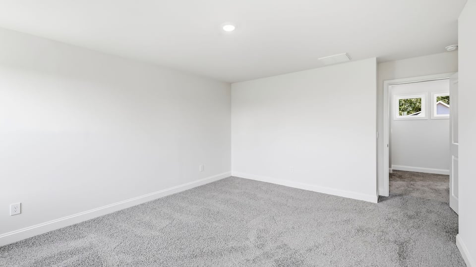 Bedroom with carpet and window.