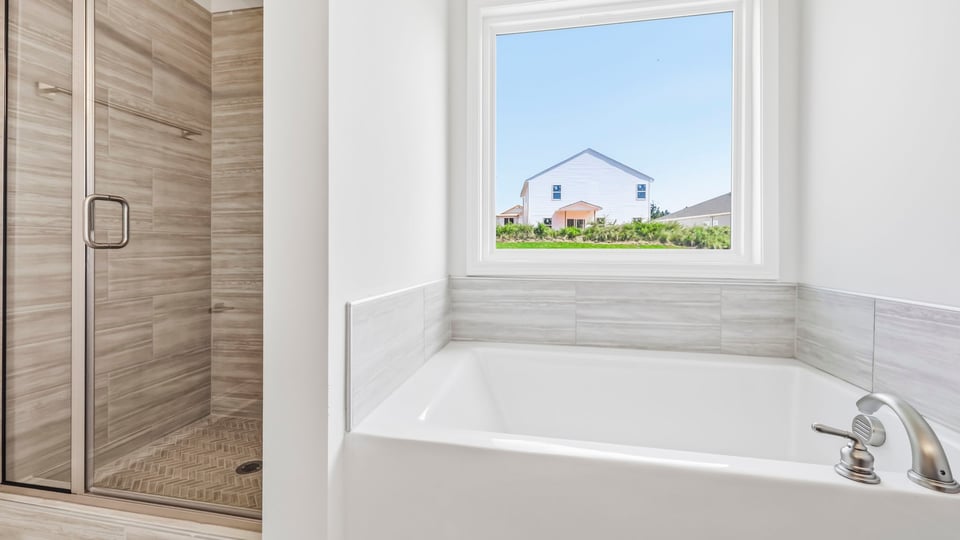 Bathroom with bathtub and walk in shower.
