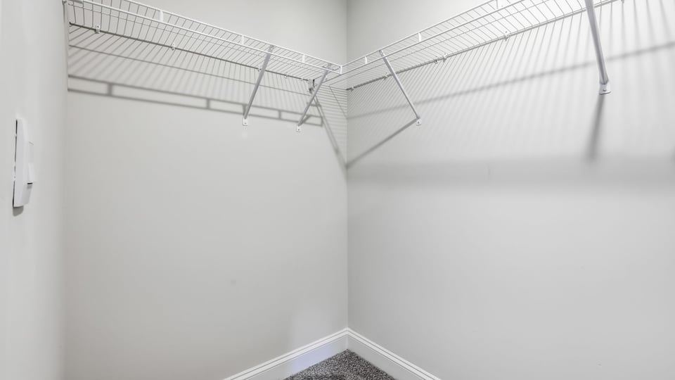 Closet with hanging storage racks.