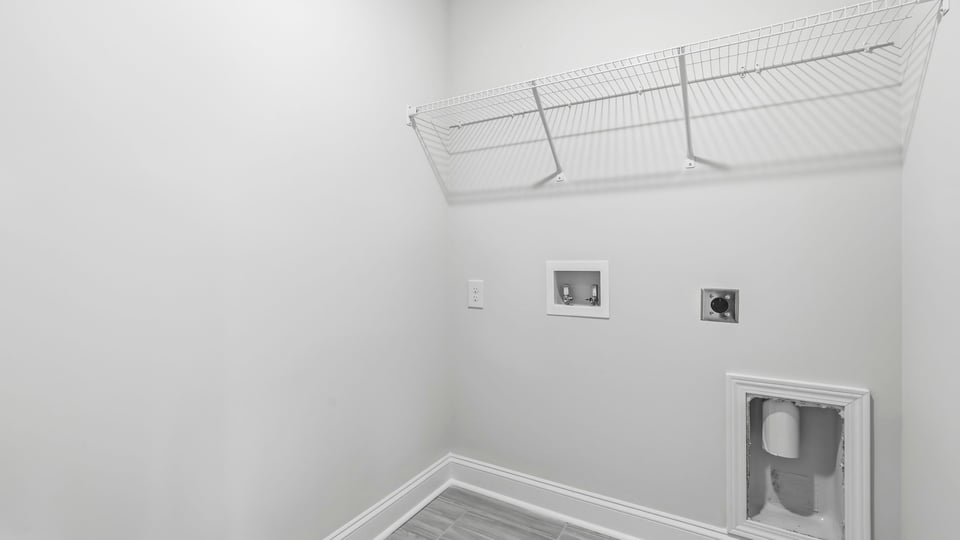 Laundry room with hanging storage racks.
