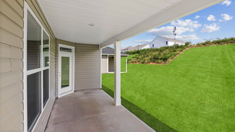 Back exterior of home with covered patio.