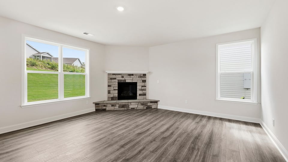 Living room with windows and fireplace.