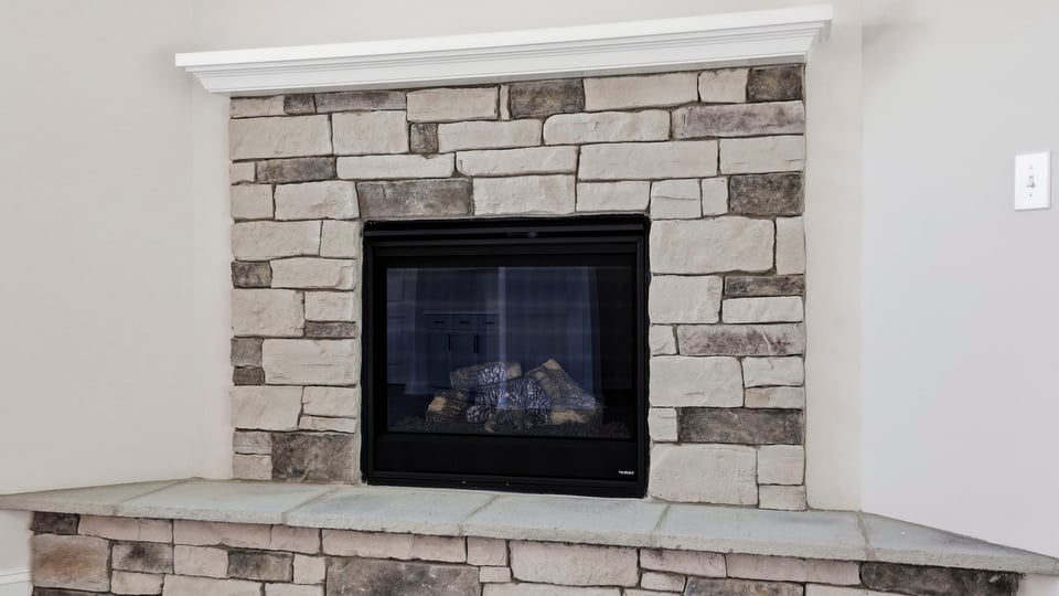 Living room with windows and fireplace.