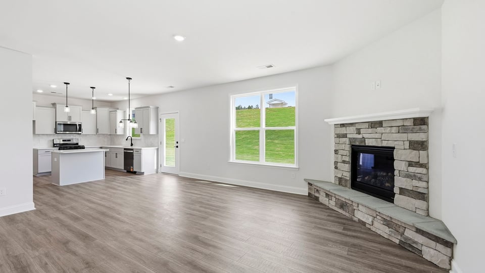 Living room with windows and fireplace.