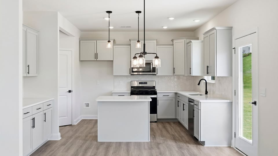 Kitchen and island with quartz countertops.