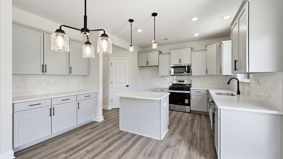 Kitchen and island with quartz countertops.