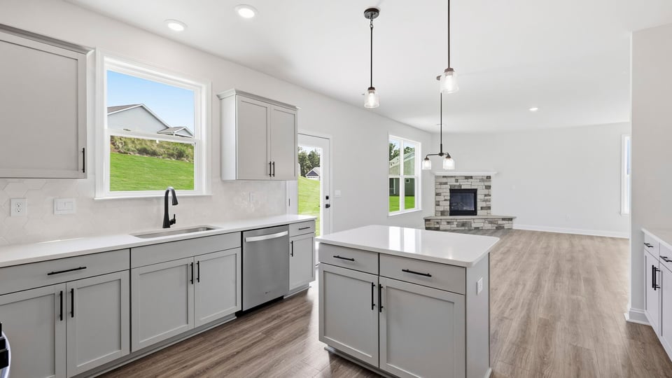 Kitchen and island with quartz countertops.
