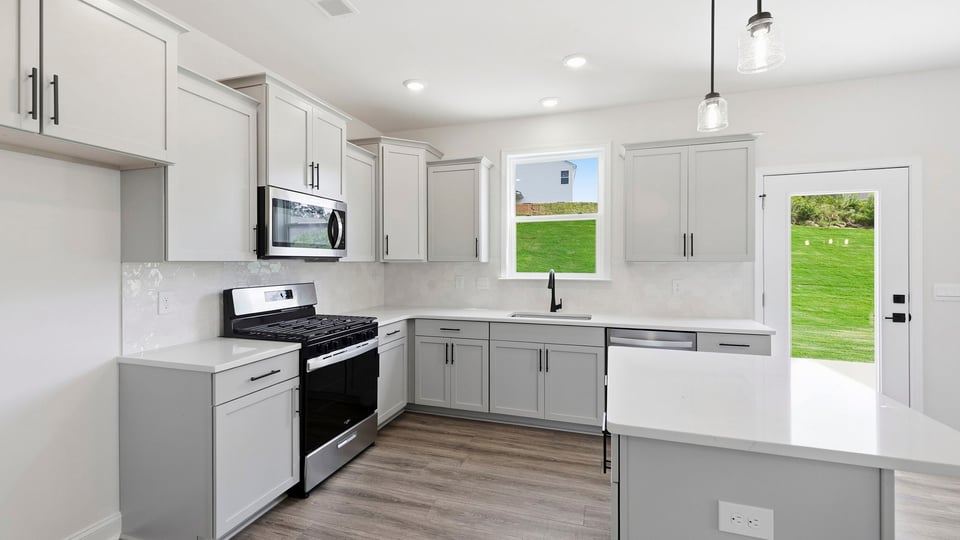 Kitchen and island with quartz countertops.