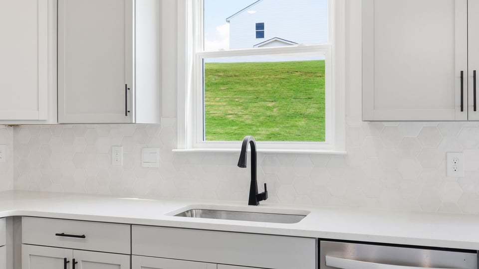 Kitchen and island with quartz countertops.