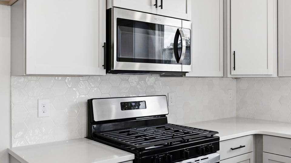 Kitchen and island with quartz countertops.